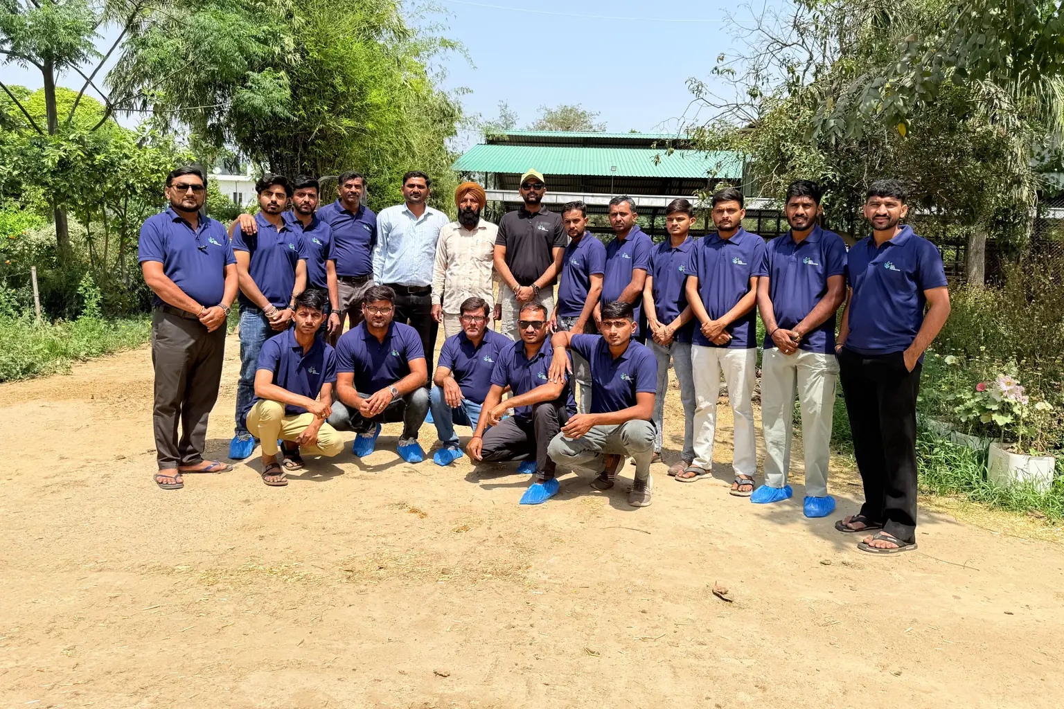 Ekta Rural Development team in branded T-shirts at a dairy farm